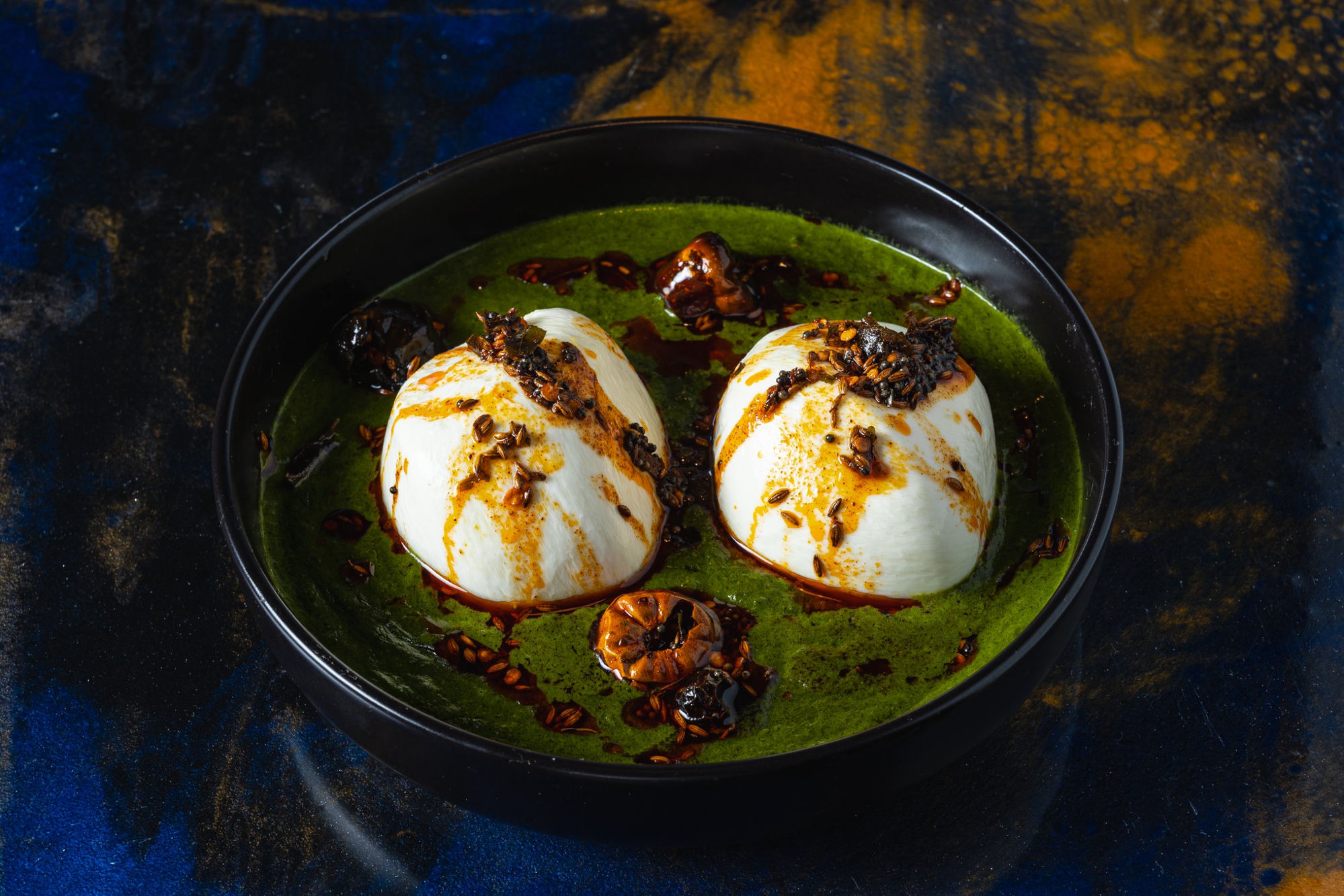 Burrata in green herb sauce with spiced oil