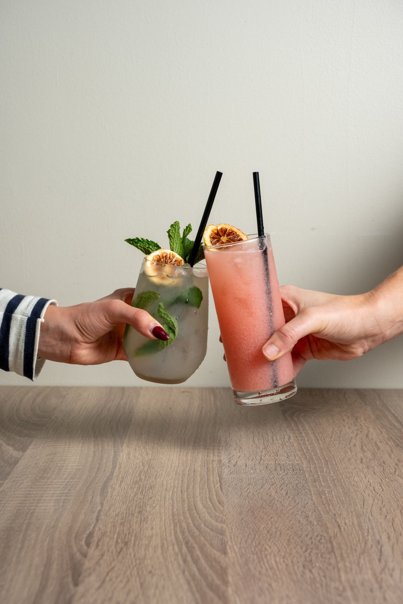 Two cocktails being clinked together